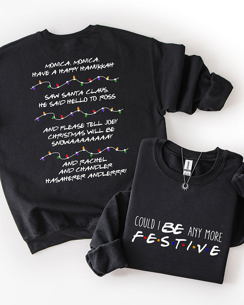 Black Friends-inspired Christmas crewneck sweatshirt featuring festive front lettering and nostalgic holiday song lyrics with multicolored Christmas lights on the back.