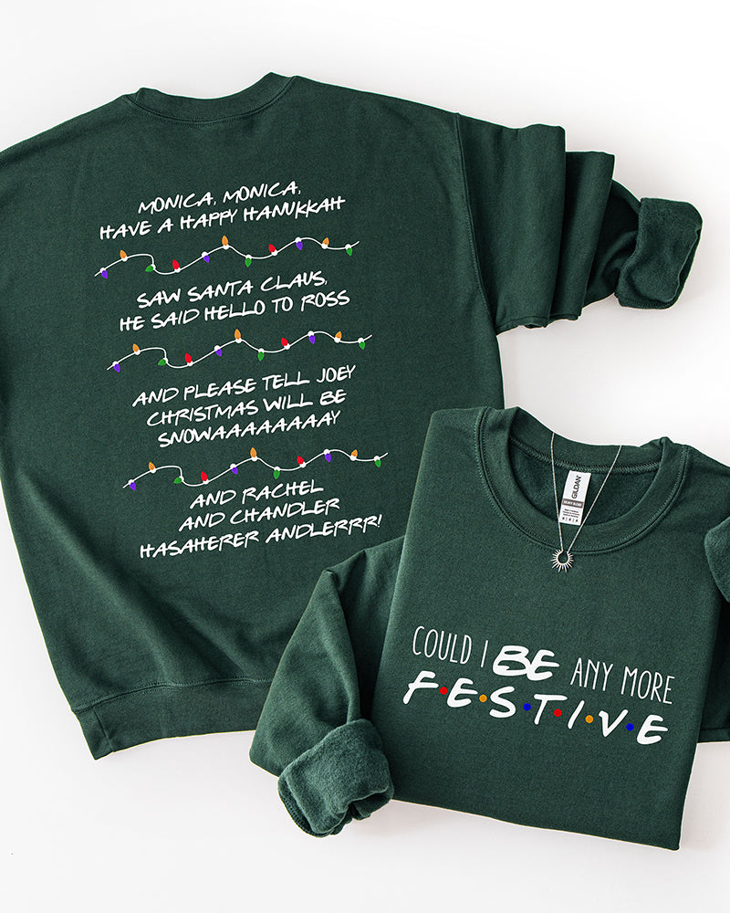 Forest green Friends-inspired Christmas crewneck sweatshirt showing Could I BE Any More Festive front lettering and Phoebe's holiday song lyrics on the back.