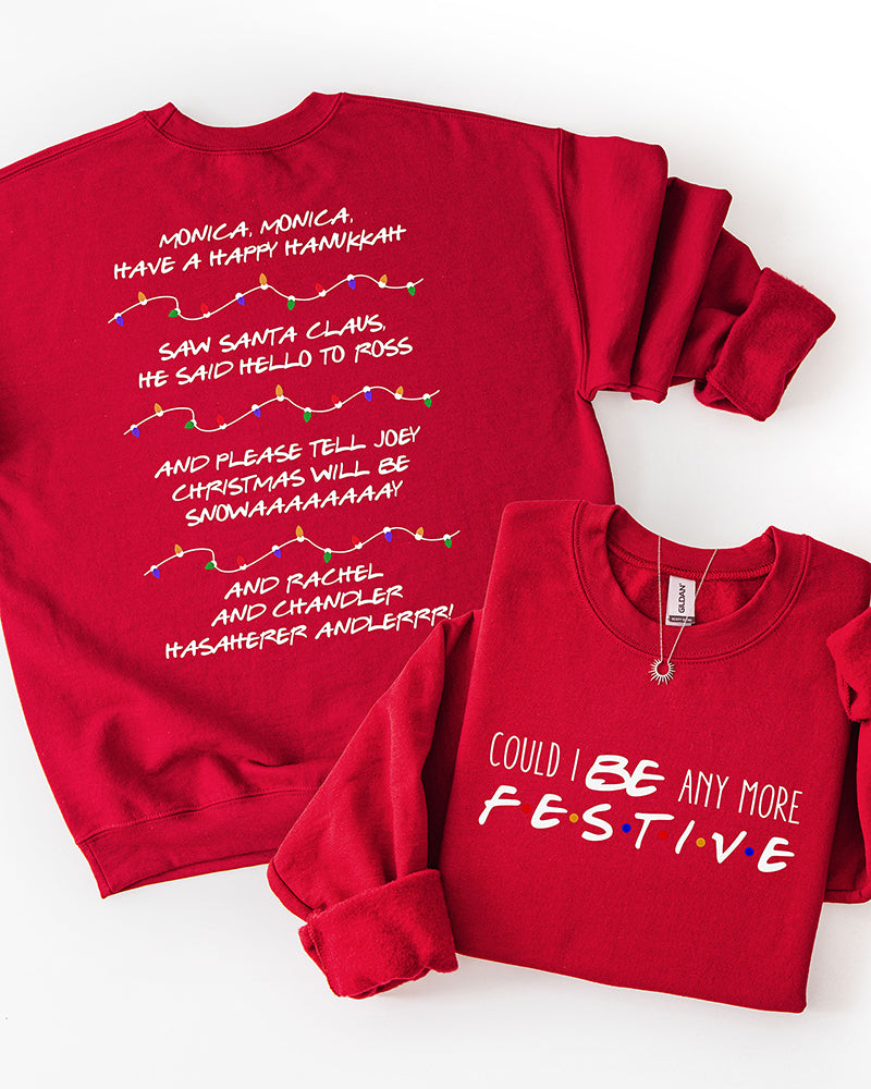 Red Could I Be Any More Festive Christmas sweatshirt with front typography and colorful Christmas light strands separating Friends-inspired lyrics on the back.