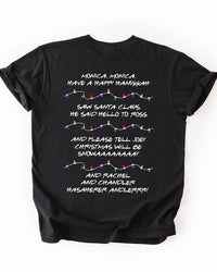 Back of black Friends-inspired Christmas heavyweight T-shirt featuring Phoebe's holiday song lyrics and colorful Christmas light illustrations.