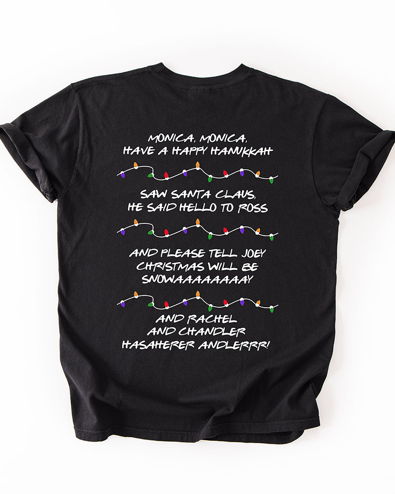 Back of black Friends-inspired Christmas heavyweight T-shirt featuring Phoebe's holiday song lyrics and colorful Christmas light illustrations.
