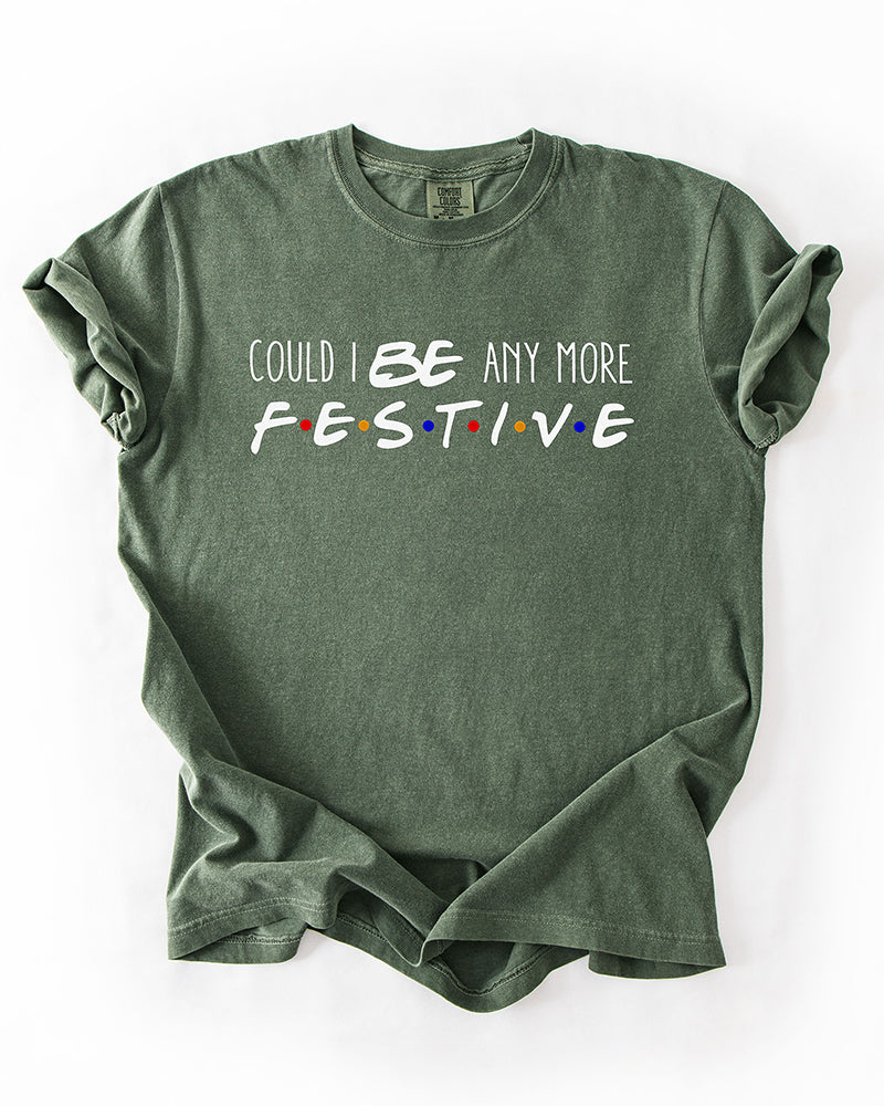 Hemp green Friends-inspired Christmas heavyweight T-shirt with Could I BE Any More Festive lettering and colorful logo-inspired dots.