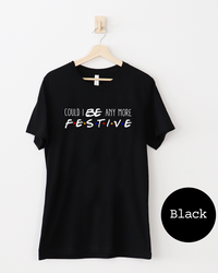 Black Friends-inspired Christmas lightweight tee with Could I BE Any More Festive graphic in white lettering and colorful dots.