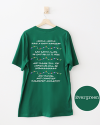 Back of evergreen Christmas T-shirt featuring nostalgic Friends holiday quotes separated by colorful strands of Christmas lights.