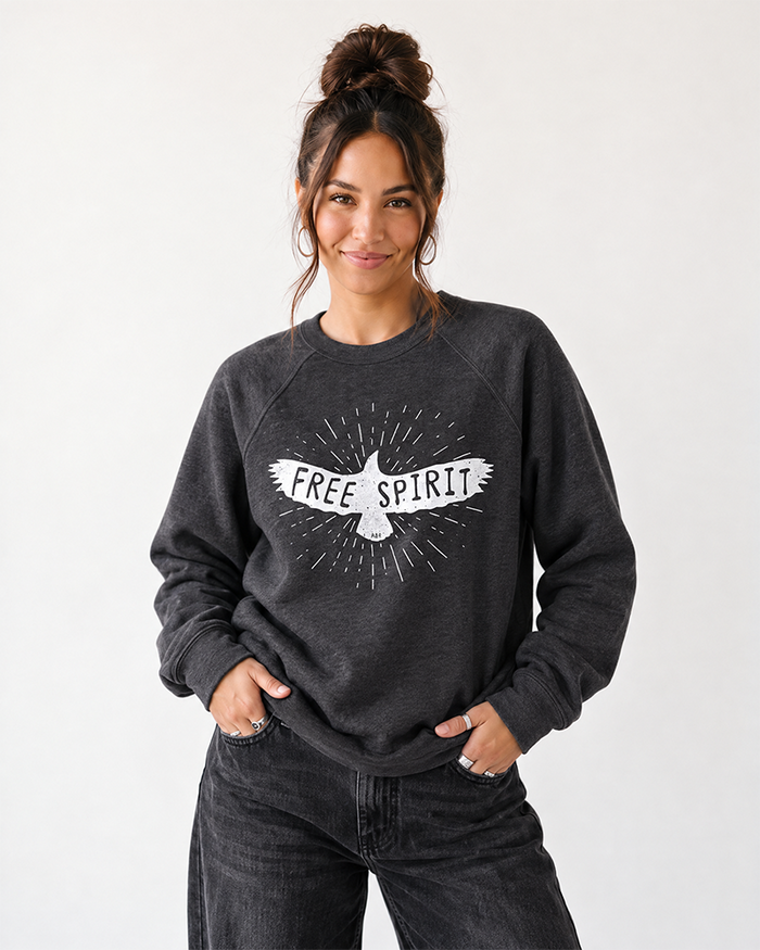 Woman wearing Free Spirit graphic raglan sweatshirt with black jeans