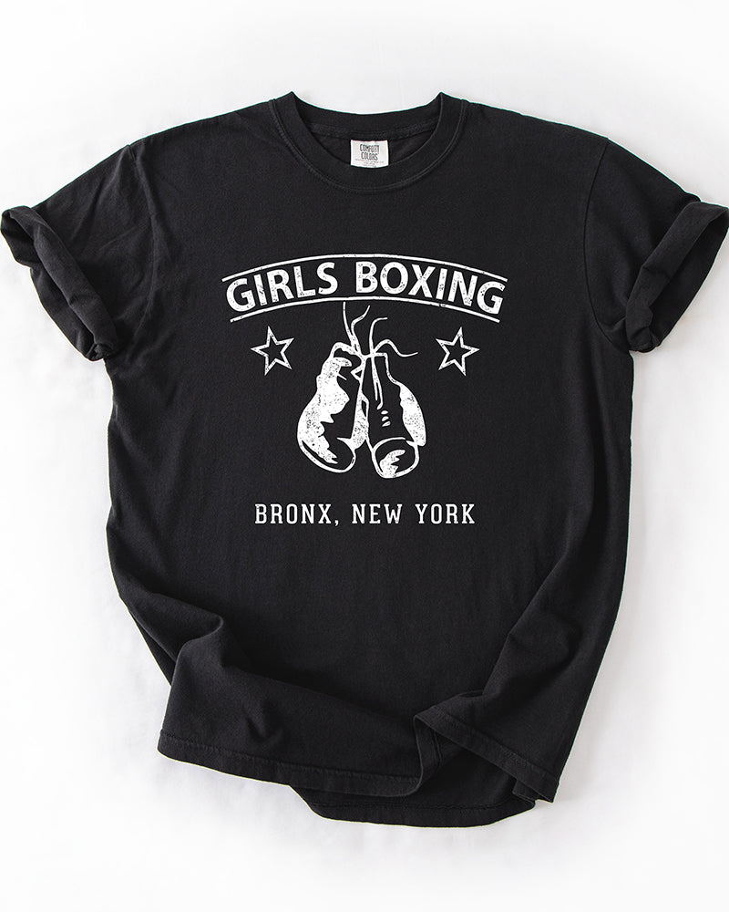Black Comfort Colors heavyweight Girls Boxing t-shirt with white hanging boxing gloves, stars and Bronx New York lettering.