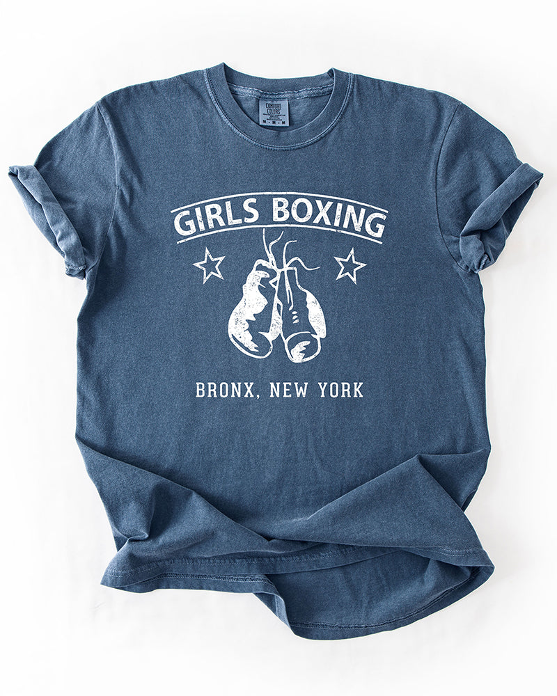 Denim blue Girls Boxing heavyweight graphic tee with distressed white boxing gloves and vintage Bronx New York lettering.