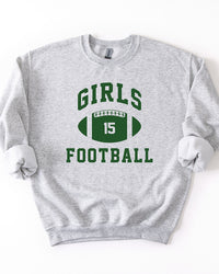 Ash gray Girls Football crewneck sweatshirt featuring forest green collegiate lettering and a number 15 football graphic.