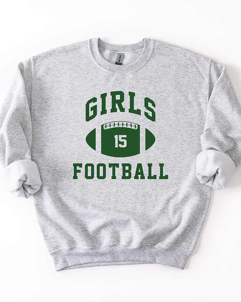 Ash gray Girls Football crewneck sweatshirt featuring forest green collegiate lettering and a number 15 football graphic.