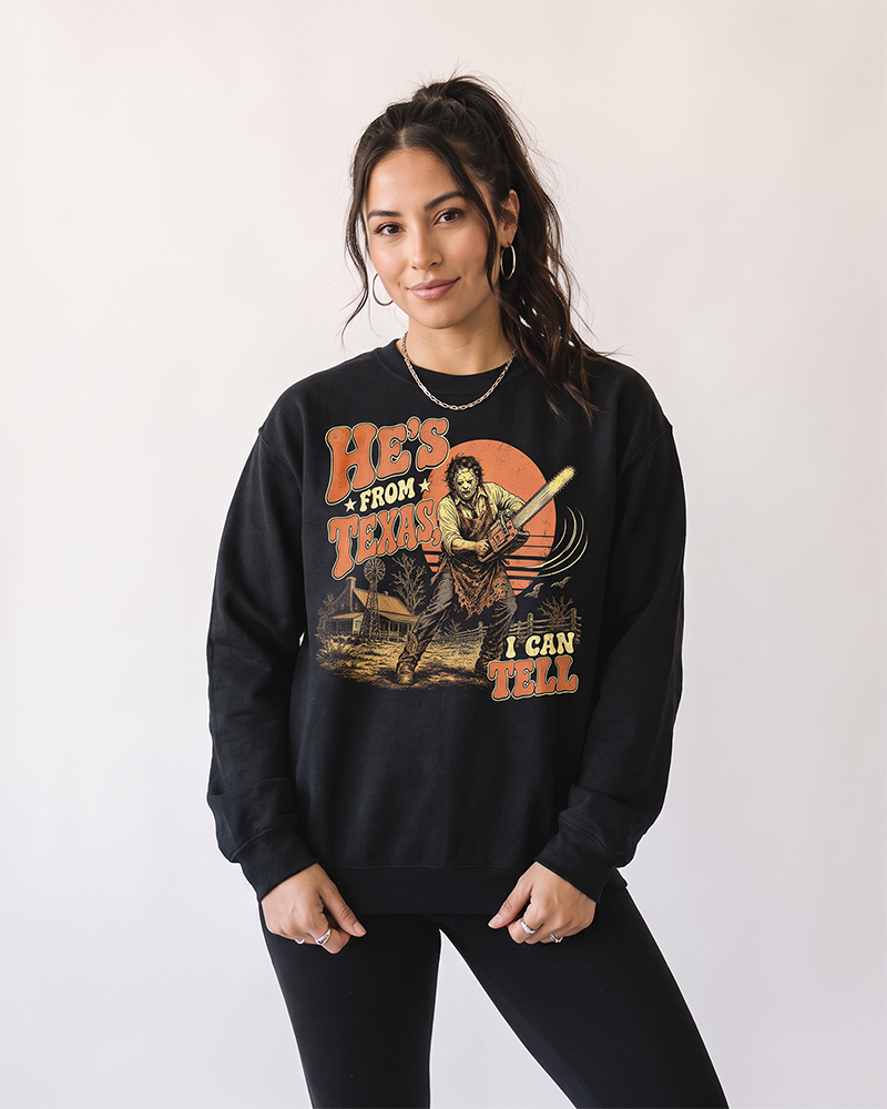 Woman wearing black He's From Texas horror Western graphic crewneck sweatshirt