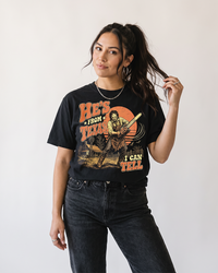 Woman wearing He's From Texas horror Western graphic tee with vintage chainsaw design