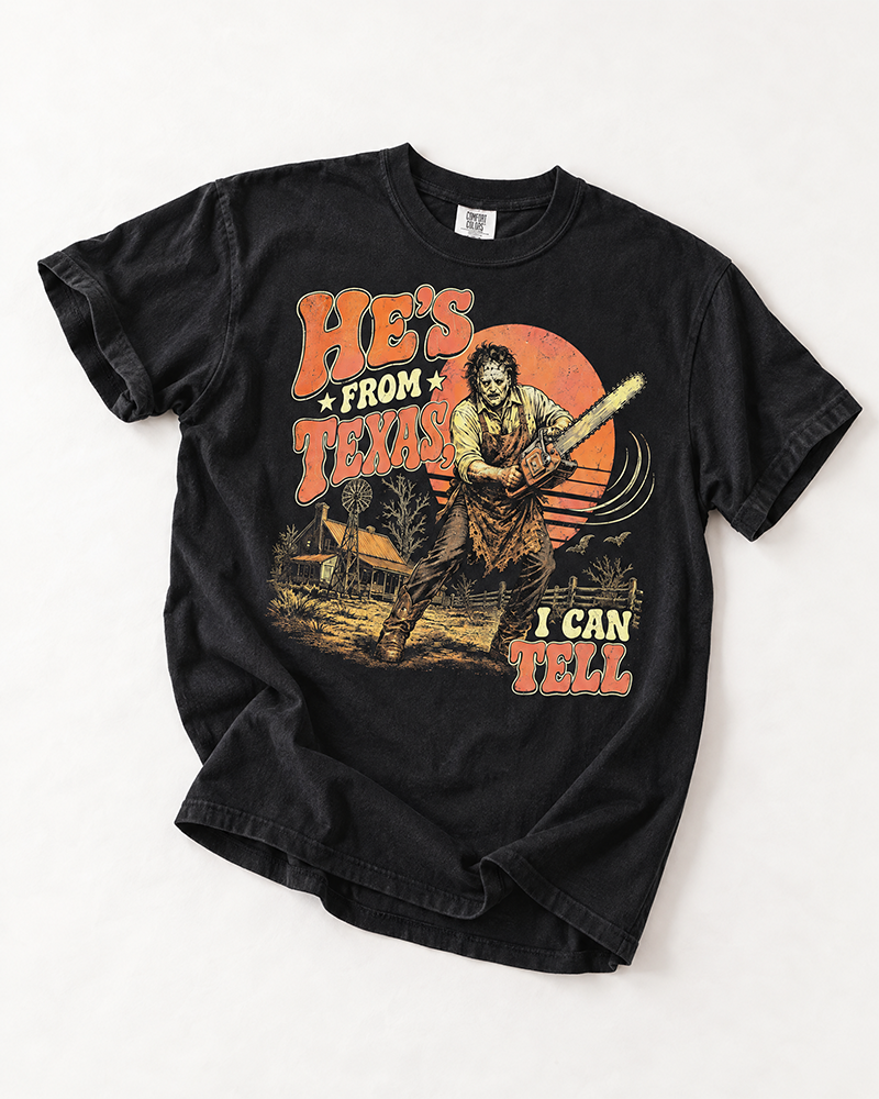 Black He's From Texas I Can Tell horror Western tee with retro chainsaw graphic