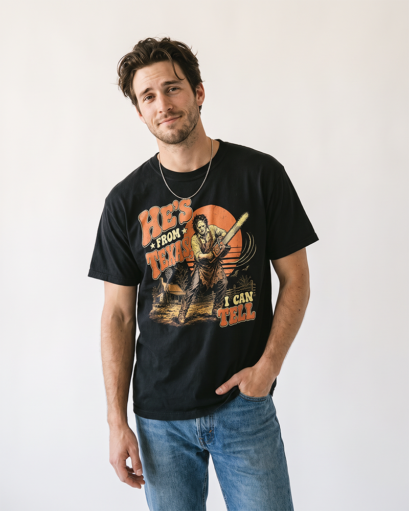 Man wearing black He's From Texas horror Western chainsaw graphic t-shirt