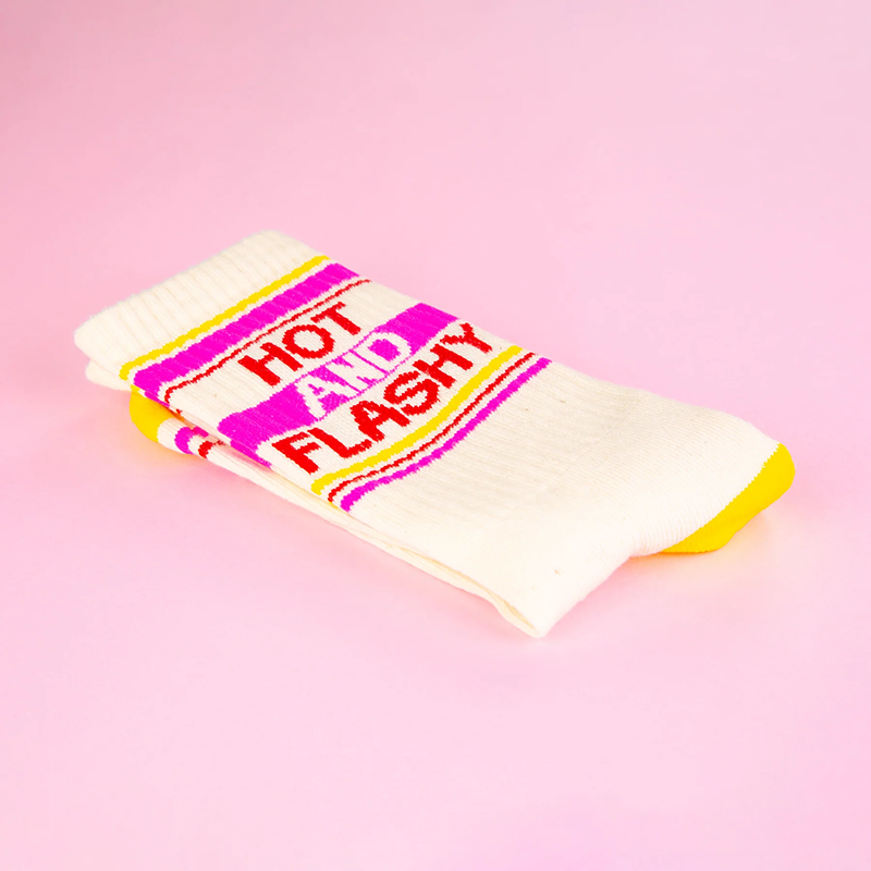 Folded Hot And Flashy cotton gym socks featuring bold red lettering and pink striped design