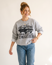 Hunting Demons Supernatural inspired crewneck sweatshirt in Ash Gray on female model