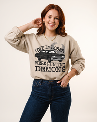 Get In Loser We're Hunting Demons Supernatural inspired sweatshirt in Sand on female model