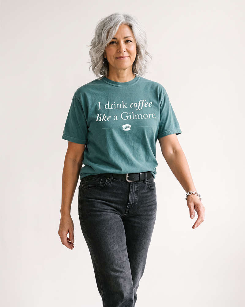 Woman wearing blue spruce coffee graphic tee with casual pants