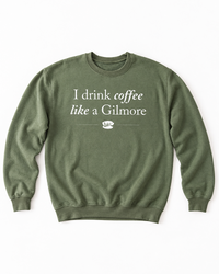 Military green I Drink Coffee Like a Gilmore sweatshirt with white lettering and Luke’s coffee cup graphic