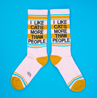 Pair of pink I Like Cats More Than People gym socks with retro turquoise and mustard yellow details