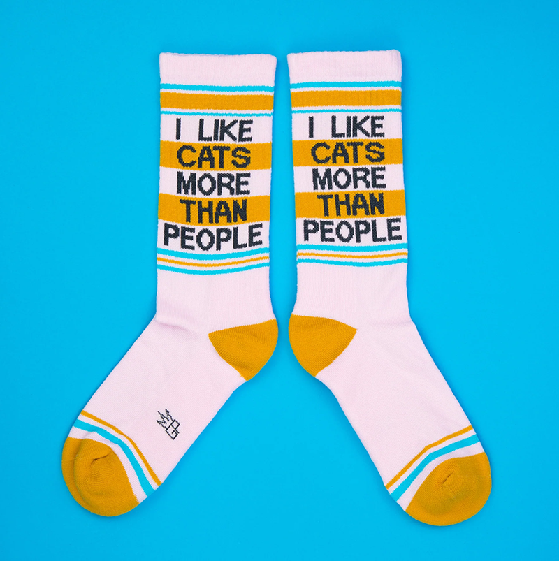 Pair of pink I Like Cats More Than People gym socks with retro turquoise and mustard yellow details