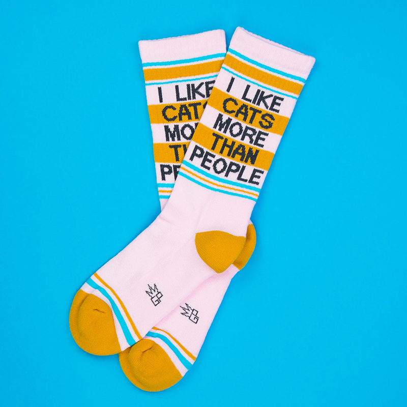 Overlapping pink cat lover socks featuring I Like Cats More Than People lettering and contrasting yellow toes