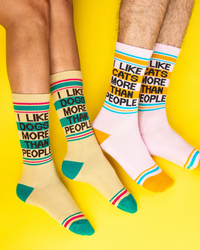 I Like Dogs More Than People yellow gym socks and matching I Like Cats More Than People pink socks worn by two models