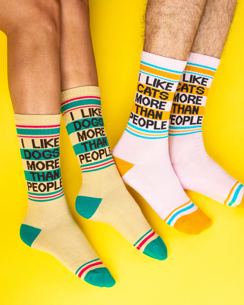 I Like Dogs More Than People yellow gym socks and matching I Like Cats More Than People pink socks worn by two models