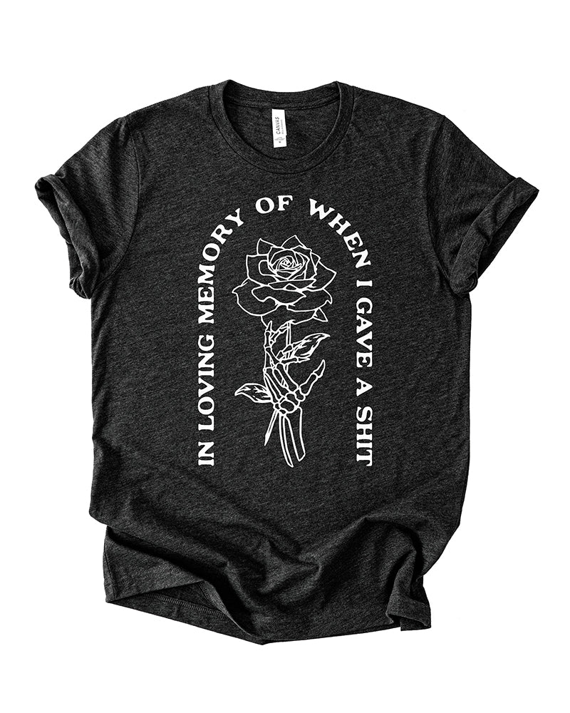 Black Heather In Loving Memory lightweight graphic tee with white skeleton hand holding a rose design