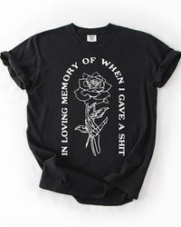 Black In Loving Memory heavyweight graphic tee with skeleton hand holding a rose and white quote design