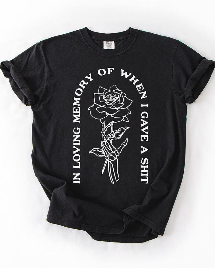 Black In Loving Memory heavyweight graphic tee with skeleton hand holding a rose and white quote design