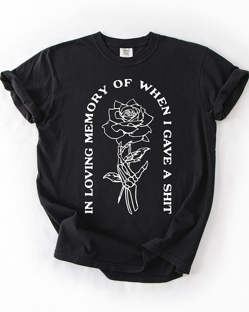Black In Loving Memory heavyweight graphic tee with skeleton hand holding a rose and white quote design