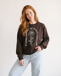 Woman wearing dark chocolate In Loving Memory sarcastic graphic crewneck sweatshirt