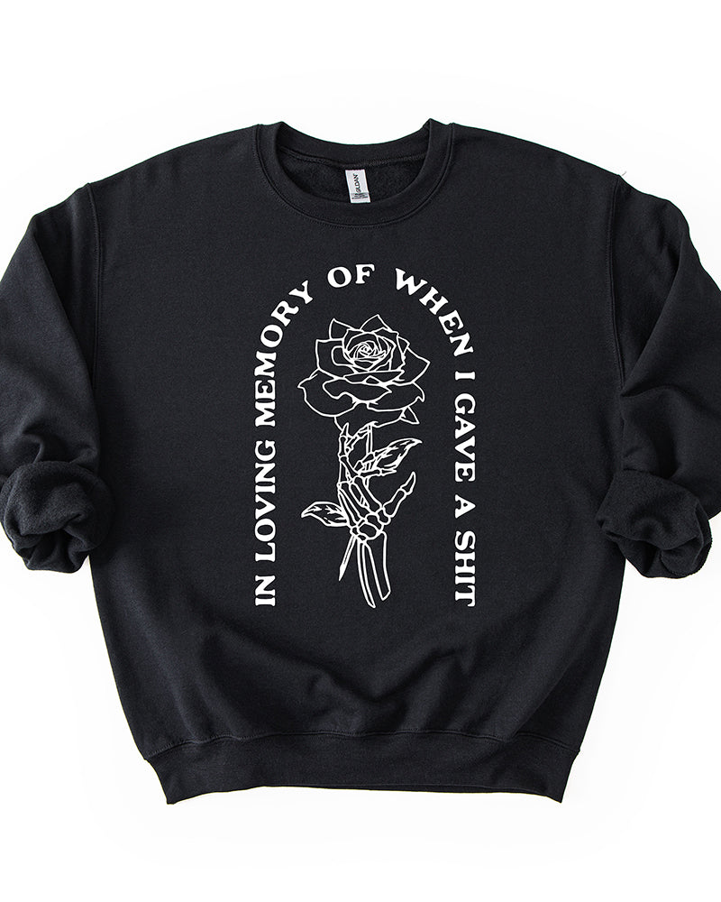 Black In Loving Memory crewneck sweatshirt with white skeleton hand holding a rose graphic