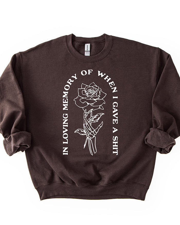 Dark chocolate brown In Loving Memory crewneck sweatshirt with white skeleton hand and rose design
