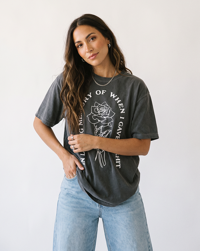 Brunette woman wearing Pepper In Loving Memory heavyweight graphic tee with skeleton rose design