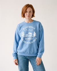 Woman modeling Carolina blue Jolliest Bunch of Assholes holiday sweatshirt