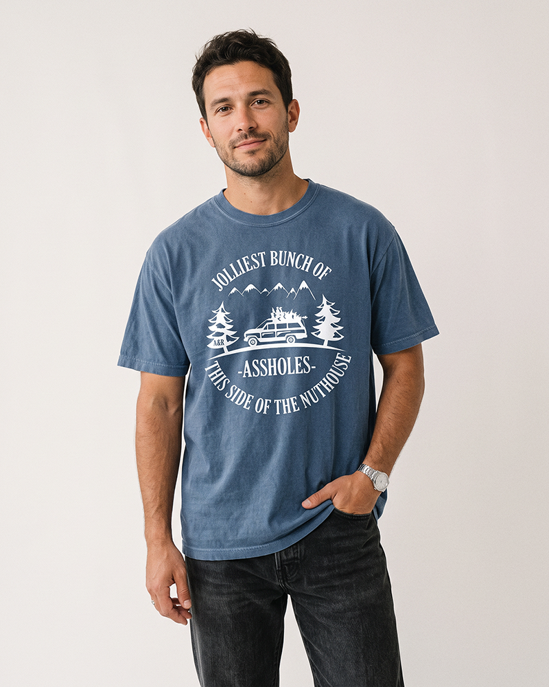 Man wearing denim Jolliest Bunch of Assholes Christmas Vacation tee