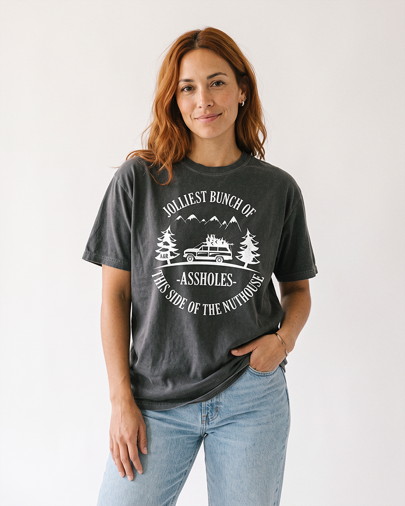 Woman wearing pepper Jolliest Bunch of Assholes funny holiday graphic tee