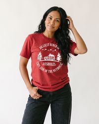 Woman wearing red Jolliest Bunch of Assholes Christmas Vacation tee