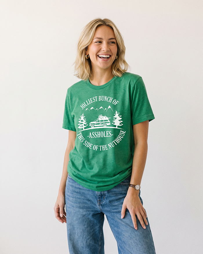 Woman wearing green Jolliest Bunch of Assholes funny Christmas tee