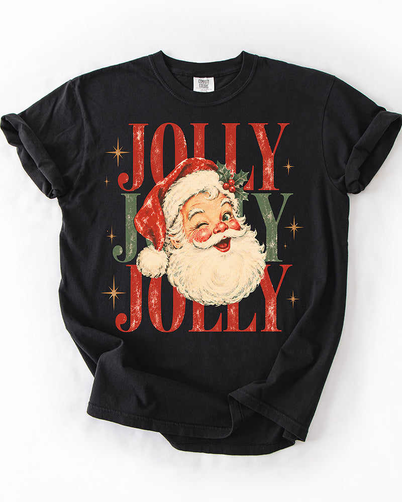 Black Comfort Colors heavyweight Christmas tee with vintage winking Santa graphic and distressed red and green Jolly Jolly Jolly lettering.