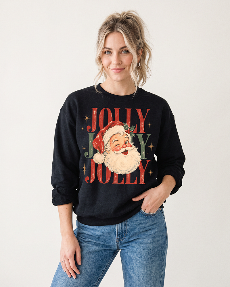 Blonde woman styling a black retro Santa Christmas sweatshirt with blue jeans, featuring a colorful vintage Jolly Santa design.