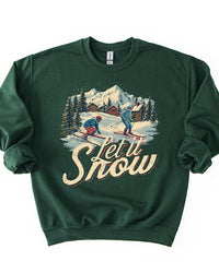 Forest green Let It Snow crewneck sweatshirt featuring retro skiers, snow-covered cabins, evergreen trees and mountain scenery.