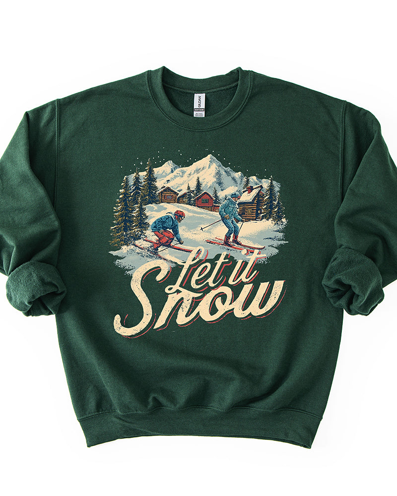 Forest green Let It Snow crewneck sweatshirt featuring retro skiers, snow-covered cabins, evergreen trees and mountain scenery.