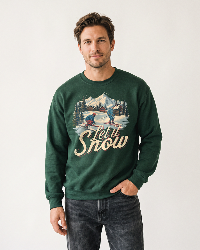 Man wearing a Forest green Let It Snow vintage ski sweatshirt with retro alpine winter artwork and dark jeans.