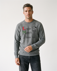 Man wearing a grey triblend Little Nero's Pizza raglan crewneck sweatshirt with black jeans