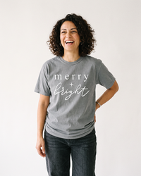 Woman wearing grey Merry + Bright heavyweight Christmas t-shirt