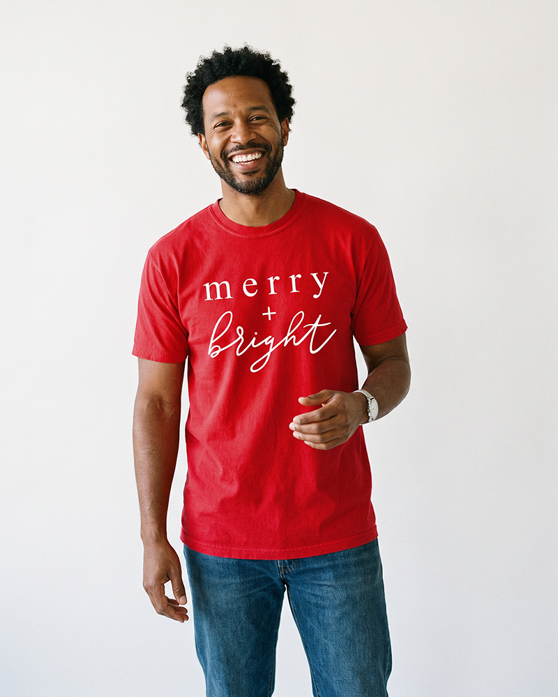 Man wearing red Merry + Bright heavyweight Christmas graphic tee