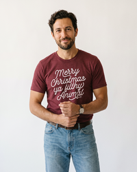 Man wearing cardinal Merry Christmas Ya Filthy Animal unisex holiday graphic tee