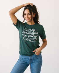 Woman wearing emerald Merry Christmas Ya Filthy Animal Christmas graphic t-shirt